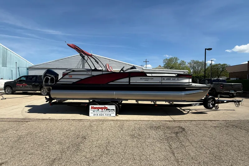 The Image of 2022 Bennington R 24 Quad Bench Bowrider on trailer, parked outdoors at Hennepin Marine. - 0