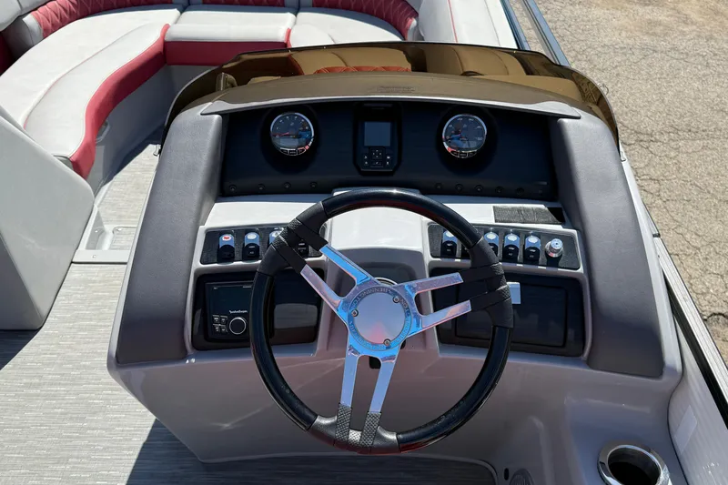 Slide: The Image of 2022 Bennington R 24 Quad Bench Bowrider dashboard with steering wheel and controls. - 13