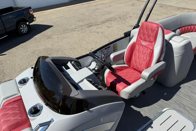Slide: The Image of 2022 Bennington R 24 Quad Bench Bowrider with red and gray seating, sleek dashboard. - 14