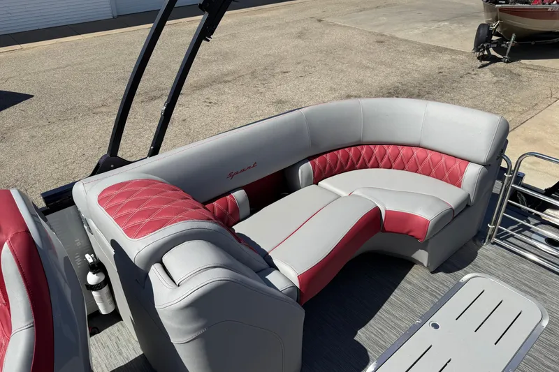 Slide: The Image of 2022 Bennington R 24 Quad Bench Bowrider with red and gray seating. - 17