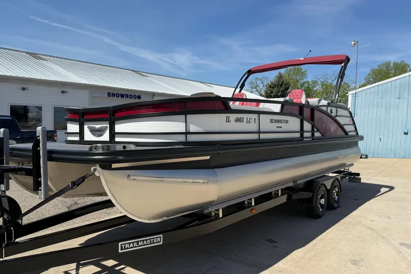 Slide: The Image of 2022 Bennington R 24 Quad Bench Bowrider on trailer outside showroom. - 3