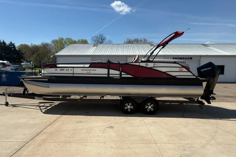 Slide: The Image of 2022 Bennington R 24 Quad Bench Bowrider on trailer outside showroom. - 4