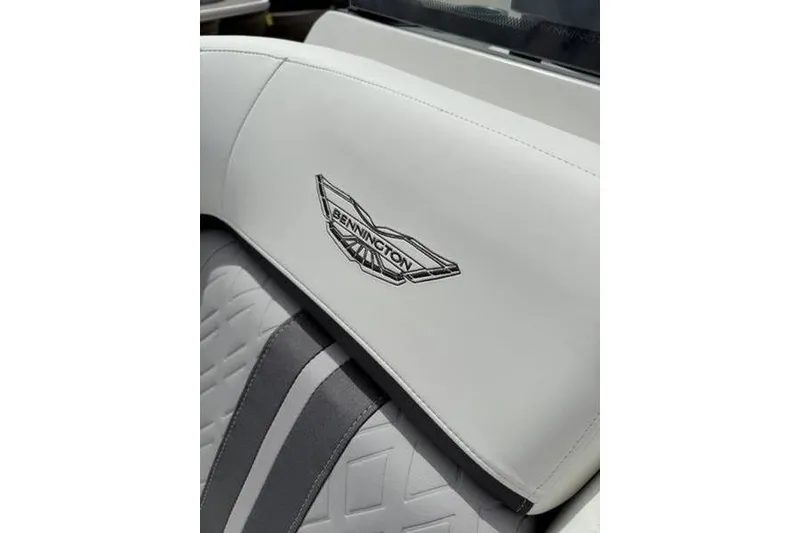 Slide: The Image of 2025 Bennington 26 MFB-SPT boat seat with logo, featuring white and gray upholstery. - 12