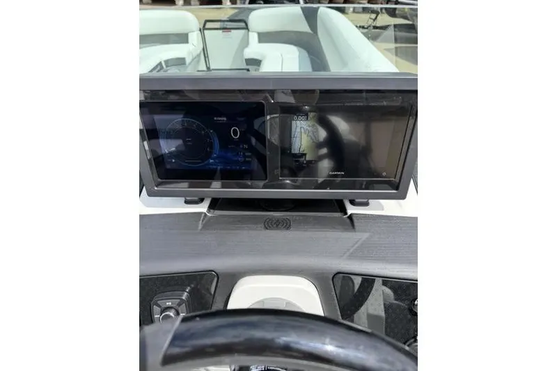 Slide: The Image of Dashboard of 2025 Bennington 26 MFB-SPT boat with digital displays and steering wheel. - 17