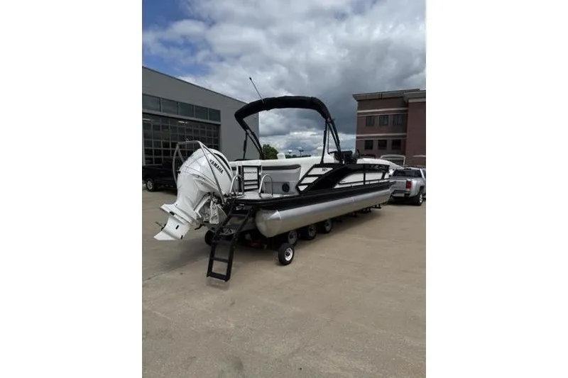Slide: The Image of 2025 Bennington 26 MFB-SPT pontoon boat with Yamaha outboard engine on trailer. - 4