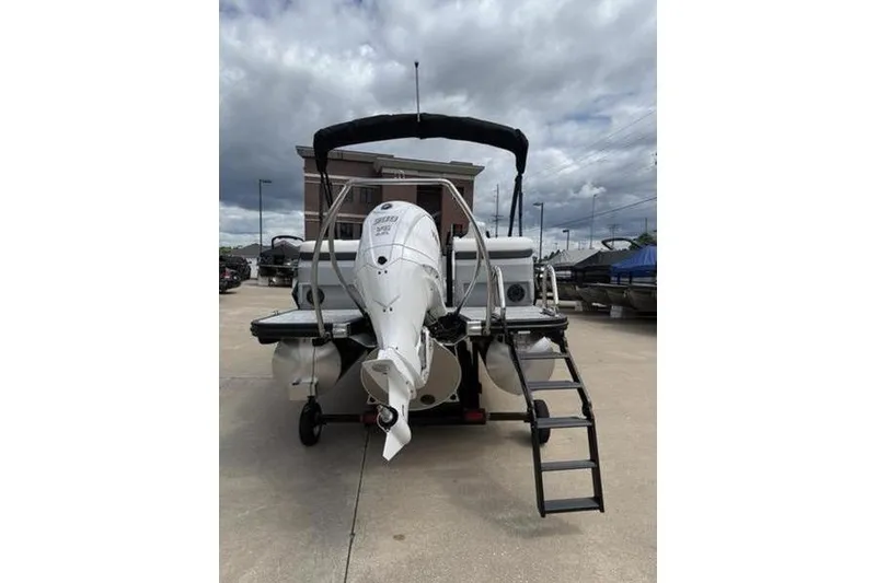 Slide: The Image of 2025 Bennington 26 MFB-SPT pontoon boat with outboard motor and boarding ladder. - 5