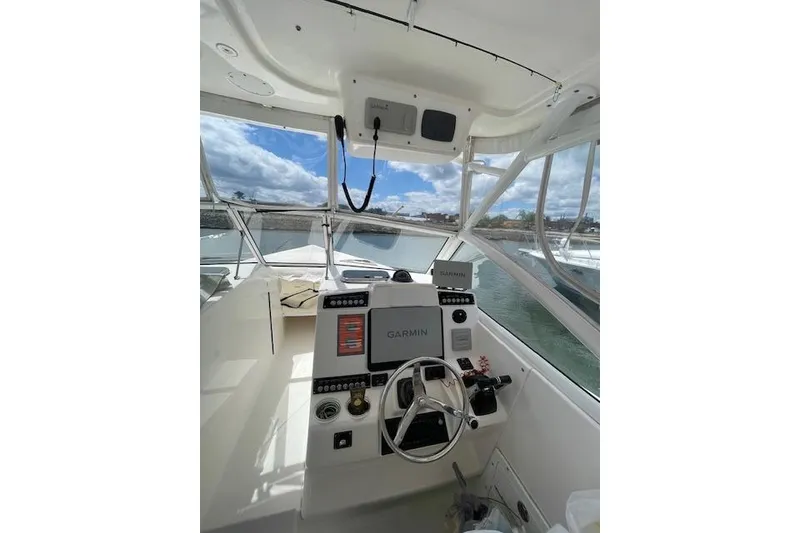 Slide: The Image of Cockpit view of 2015 Edgewater 280CX Crossover boat with Garmin navigation system. - 10