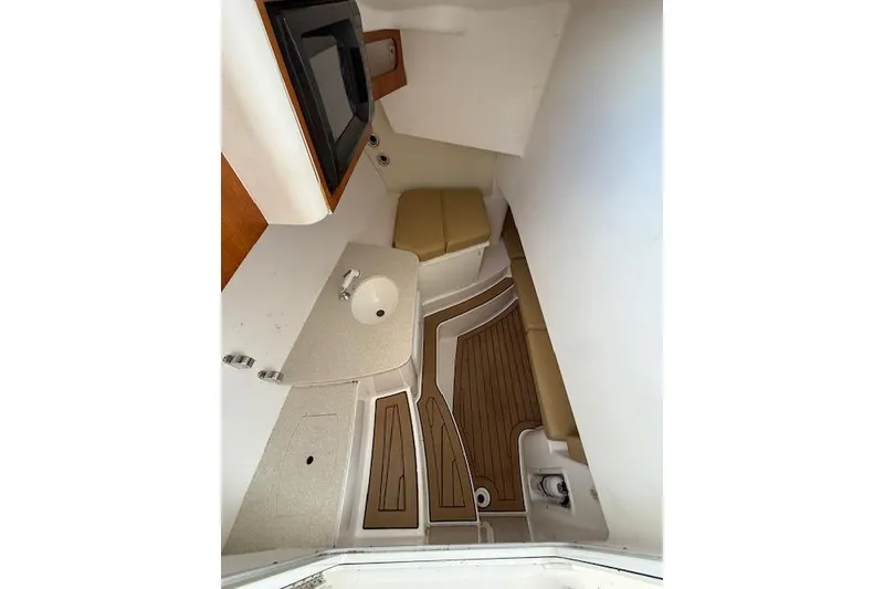 Slide: The Image of Interior of 2015 Edgewater 280CX Crossover boat with seating and compact amenities. - 15
