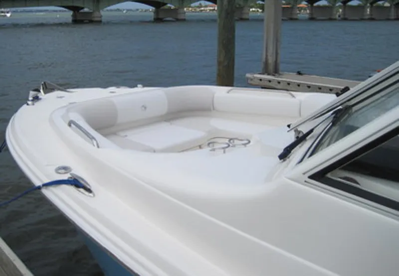 Slide: The Image of Manufacturer Provided Image: 2015 Edgewater 280CX Crossover boat docked by a bridge on calm water. - 3
