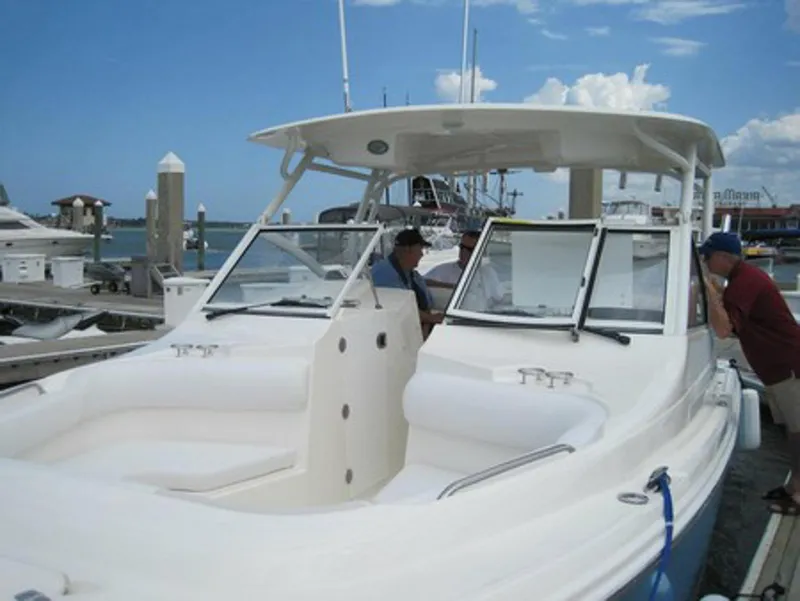 Slide: The Image of Manufacturer Provided Image: 2015 Edgewater 280CX Crossover boat docked at marina under clear blue sky. - 4