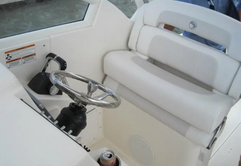 Slide: The Image of Manufacturer Provided Image: Helm of 2015 Edgewater 280CX Crossover boat with white seating and steering wheel. - 5