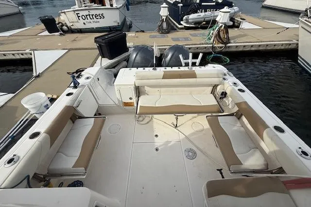 Slide: The Image of 2015 Edgewater 280CX Crossover boat interior with spacious seating at dock. - 7