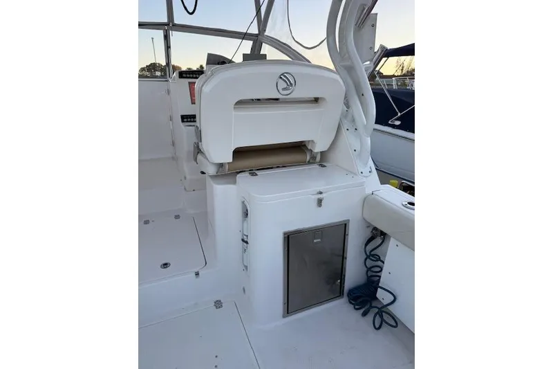 Slide: The Image of Interior view of a 2015 Edgewater 280CX Crossover boat, featuring seating and storage. - 8