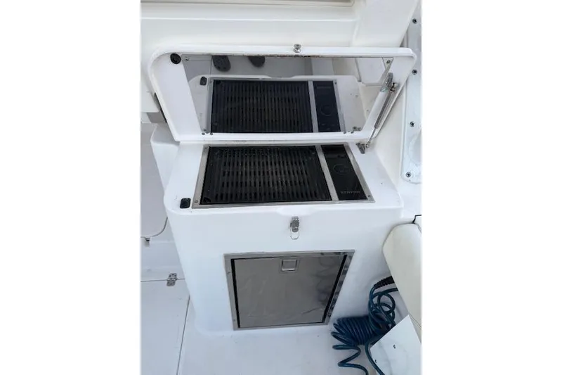 Slide: The Image of Built-in grill and storage on 2015 Edgewater 280CX Crossover boat. - 9