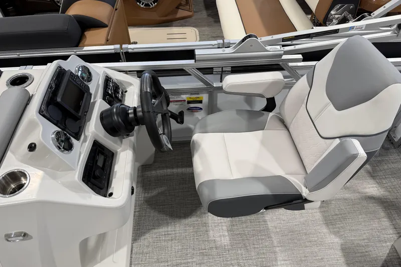 Slide: The Image of Interior of 2026 Avalon 2185 VENTURE 85 VRB boat with steering console and captain's chair. - 12