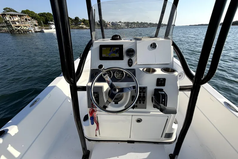 Slide: The Image of 2015 Epic 22 Sport Console boat dashboard with steering wheel and navigation system. - 10