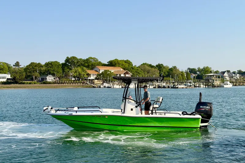 Slide: The Image of 2015 Epic 22 Sport Console boat cruising near a bridge on a sunny day. - 3