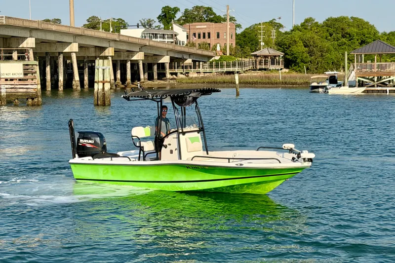 Slide: The Image of 2015 Epic 22 Sport Console boat on water, vibrant green hull, bridge in background. - 4