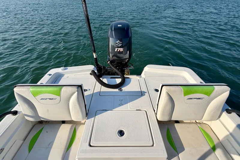 Slide: The Image of 2015 Epic 22 Sport Console boat with Suzuki engine on calm water. - 5