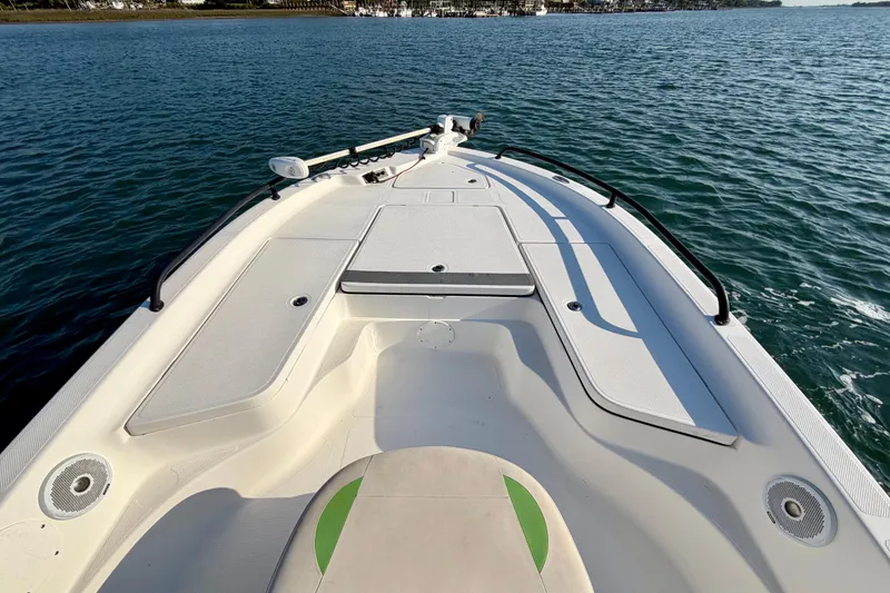 Slide: The Image of 2015 Epic 22 Sport Console boat on calm water, showcasing spacious deck design. - 8