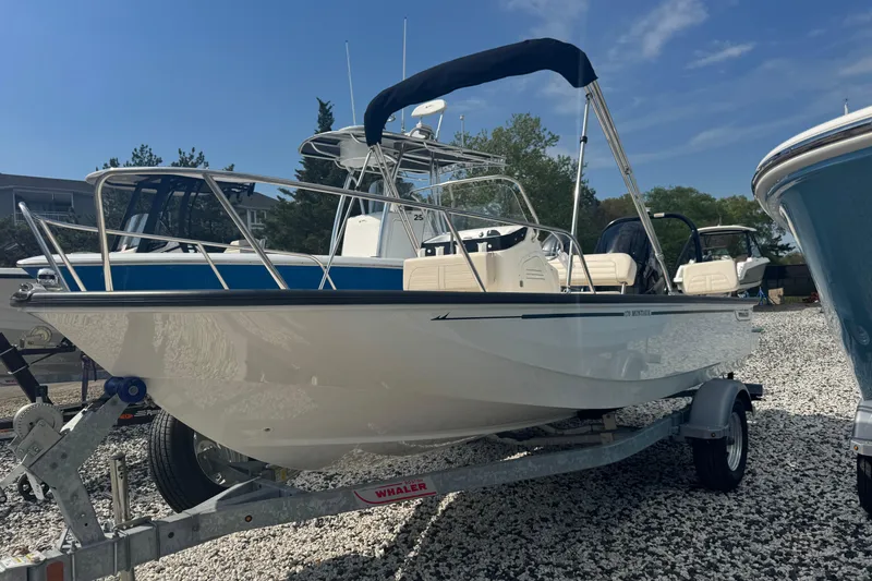The Image of 2026 Boston Whaler 170 Montauk boat on trailer, displayed outdoors under clear sky. - 0