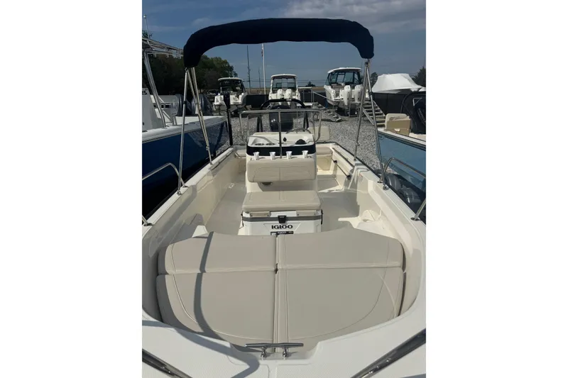 Slide: The Image of 2026 Boston Whaler 170 Montauk boat with seating and canopy, displayed outdoors. - 31