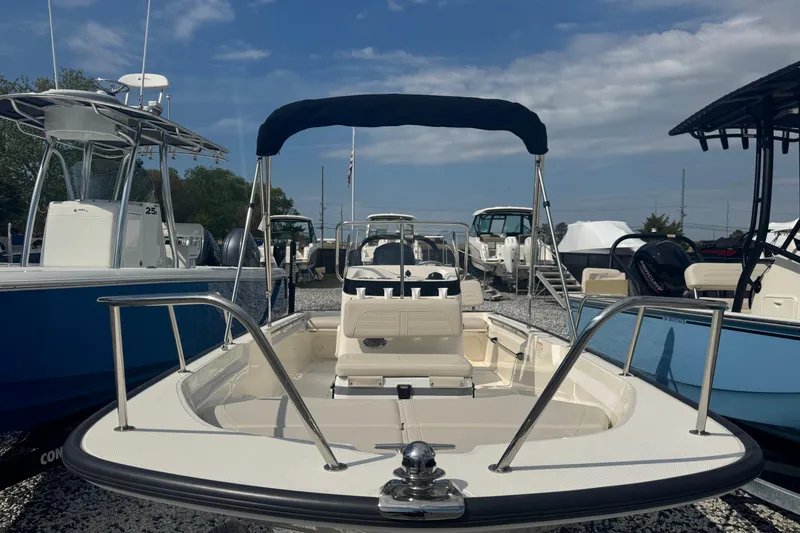 Slide: The Image of 2026 Boston Whaler 170 Montauk boat with canopy, displayed outdoors under a blue sky. - 32
