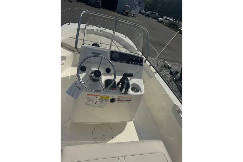 Slide: The Image of 2026 Boston Whaler 170 Montauk boat interior with steering wheel and control panel. - 34