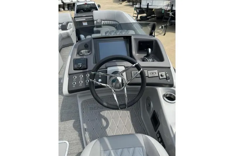 Slide: The Image of 2025 Bennington 27 QXFBAT2 boat dashboard with steering wheel and control panel. - 12