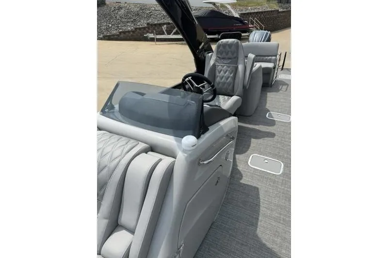 Slide: The Image of 2025 Bennington 27 QXFBAT2 boat interior with luxurious seating and modern helm. - 17