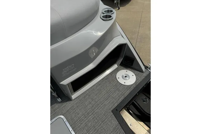 Slide: The Image of 2025 Bennington 27 QXFBAT2 boat interior with cup holders and storage compartment. - 19