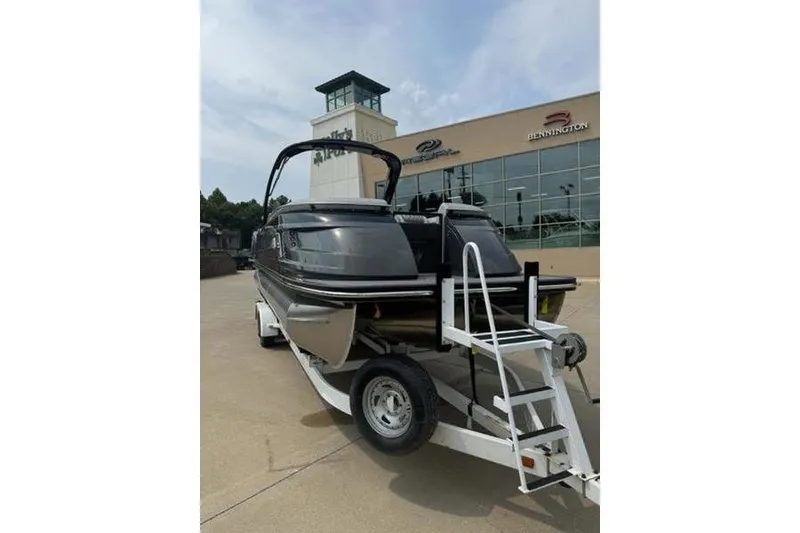 Slide: The Image of 2025 Bennington 27 QXFBAT2 boat on trailer outside dealership. - 4