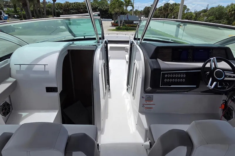 Slide: The Image of 2019 Four Winns H350 OB boat interior with helm and seating area. - 15