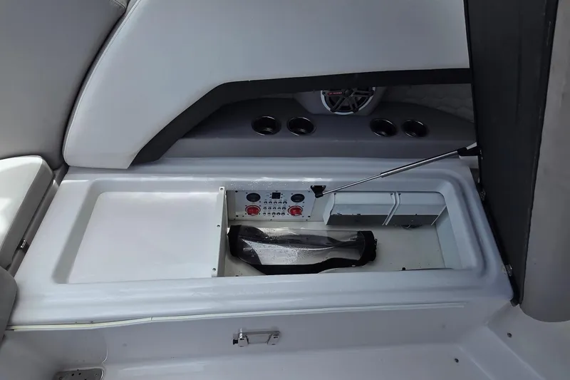 Slide: The Image of 2019 Four Winns H350 OB boat storage compartment with speaker and cup holders. - 16