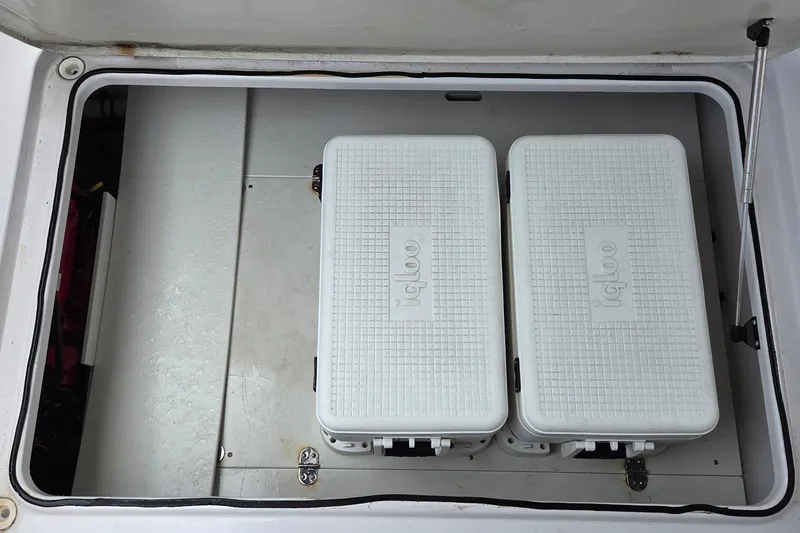 Slide: The Image of Storage compartment with two Igloo coolers on a 2019 Four Winns H350 OB boat. - 17