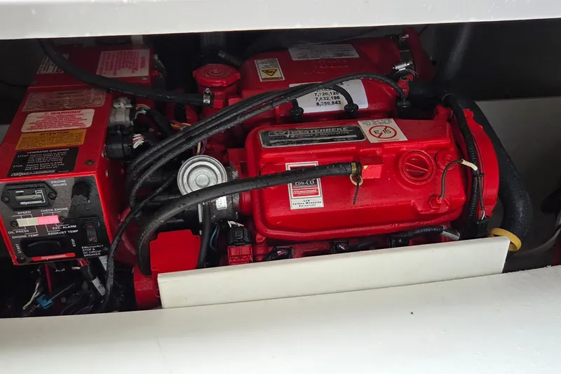 Slide: The Image of Engine compartment of a 2019 Four Winns H350 OB boat, featuring red mechanical components. - 18