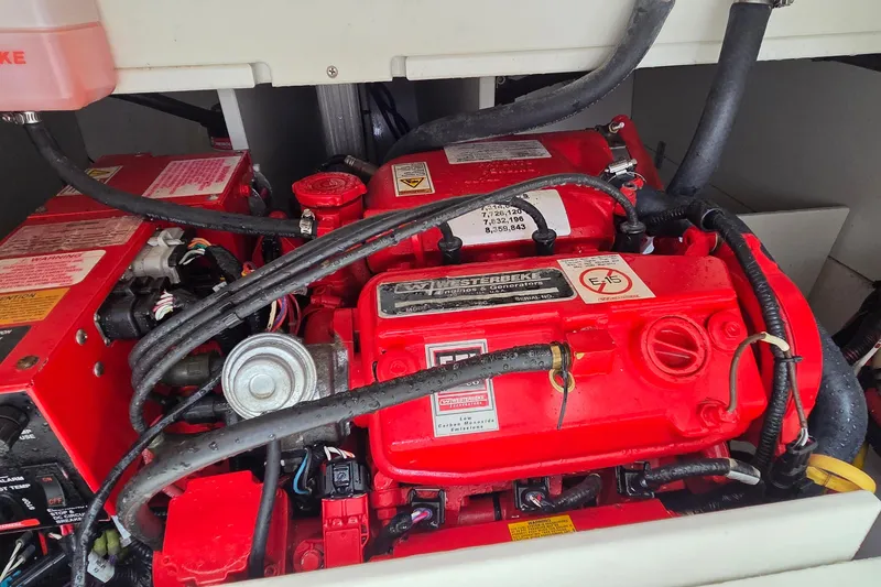 Slide: The Image of Engine compartment of a 2019 Four Winns H350 OB boat, featuring a red Westerbeke generator. - 19