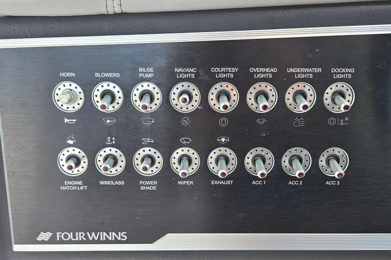 Slide: The Image of Control panel of a 2019 Four Winns H350 OB boat with labeled switches. - 20
