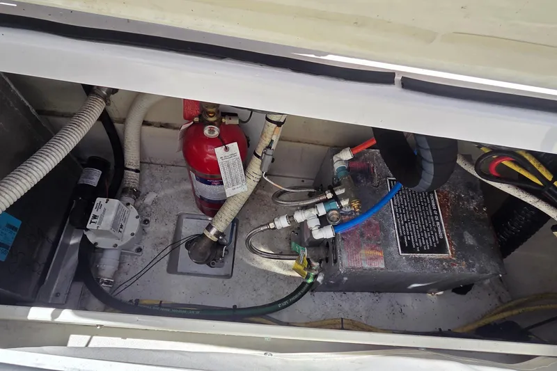 Slide: The Image of Engine compartment of 2019 Four Winns H350 OB with fire extinguisher and wiring. - 27