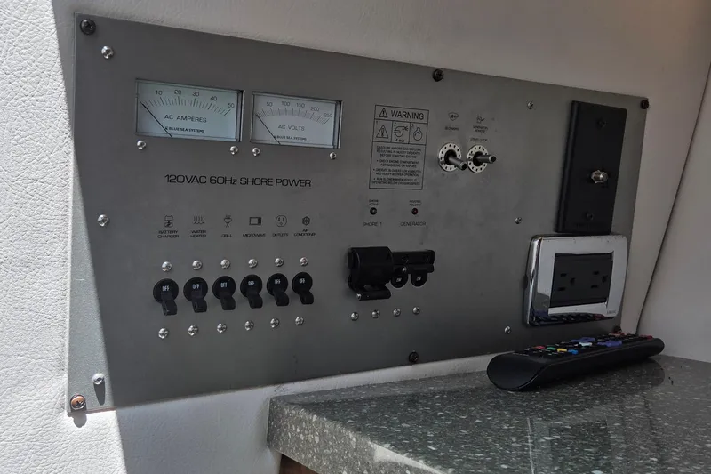 Slide: The Image of Control panel of 2019 Four Winns H350 OB boat with switches and power outlets. - 29