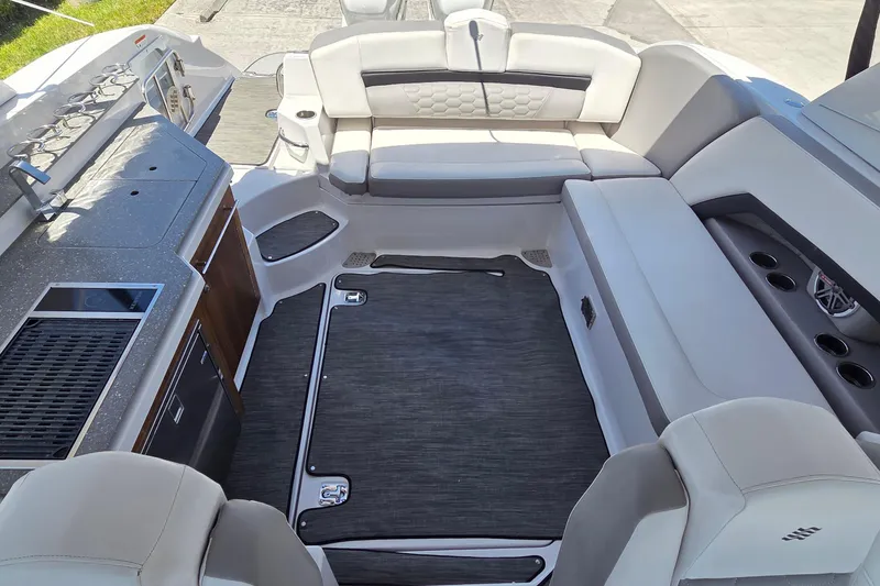 Slide: The Image of 2019 Four Winns H350 OB boat interior with seating and kitchenette area. - 30