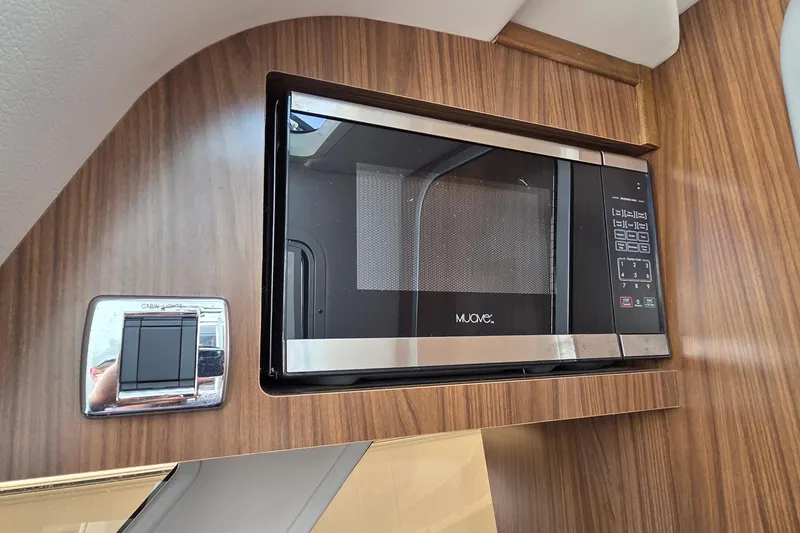 Slide: The Image of Microwave in 2019 Four Winns H350 OB boat interior, wood paneling. - 38