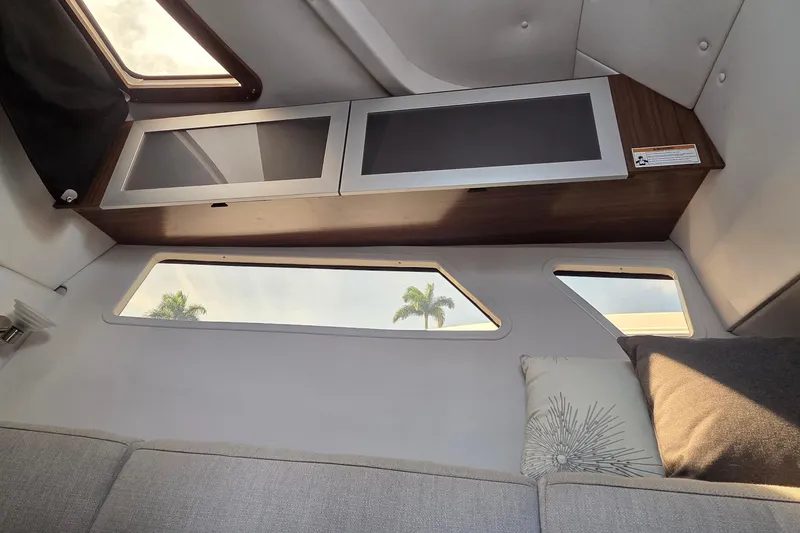 Slide: The Image of Interior cabin of 2019 Four Winns H350 OB boat with modern cabinetry and windows. - 39