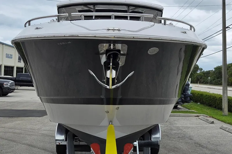 Slide: The Image of 2019 Four Winns H350 OB boat on trailer, front view, parked outdoors. - 4