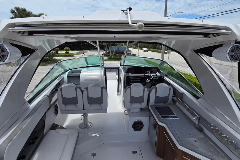 Slide: The Image of Interior view of 2019 Four Winns H350 OB boat, featuring modern seating and dashboard. - 7