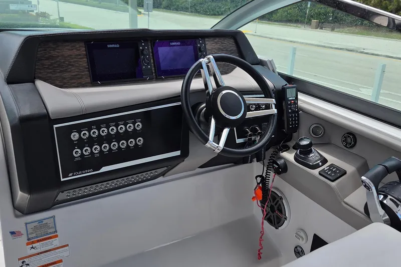 Slide: The Image of 2019 Four Winns H350 OB helm with advanced controls and dual Simrad displays. - 8