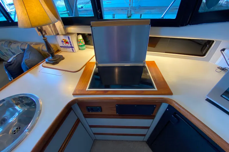 Slide: The Image of Interior of 1991 Carver 28 Command Bridge with kitchenette and modern amenities. - 14