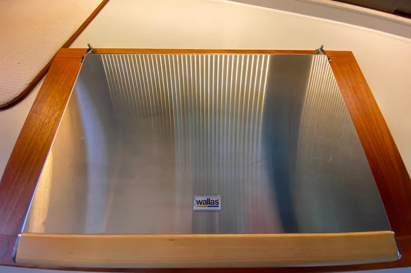 Slide: The Image of Wallas stove cover on 1991 Carver 28 Command Bridge, featuring wood and metal design. - 16