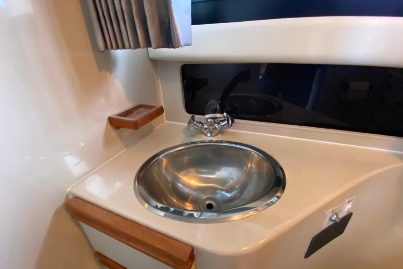 Slide: The Image of Stainless steel sink in 1991 Carver 28 Command Bridge yacht bathroom. - 23