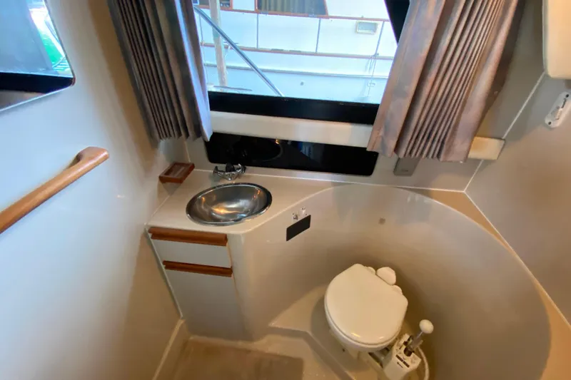 Slide: The Image of Bathroom interior of 1991 Carver 28 Command Bridge with sink and toilet. - 24